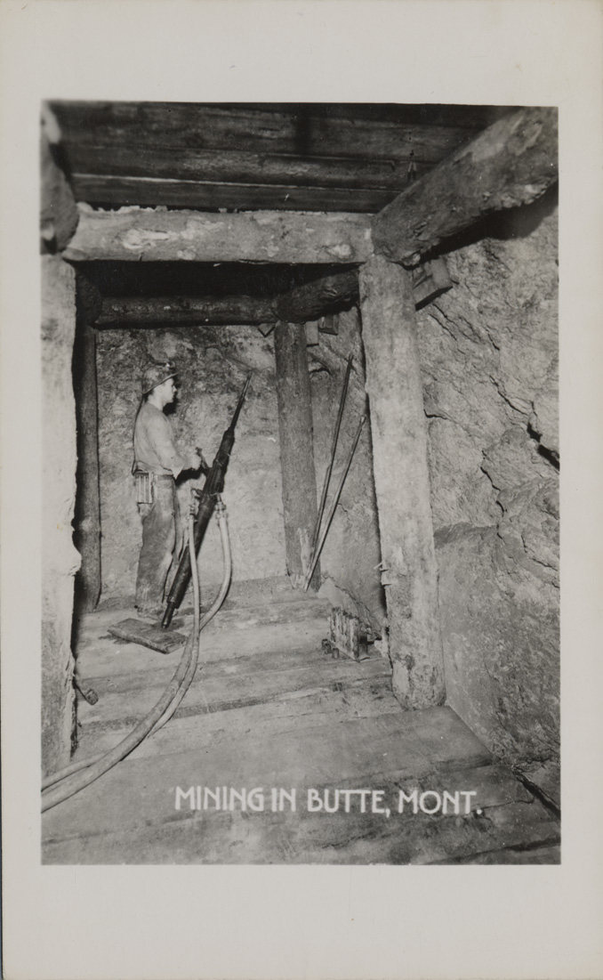 Mining in Butte, Montana. Miner drilling underground.